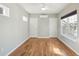 Bright bedroom with hardwood floors, two windows, and two doors, one leading outside, other to closet at 1144 Clearspring Dr, Charleston, SC 29412