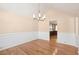 Bright dining room with wainscoting, modern chandelier, hardwood floors, and access to the kitchen at 1144 Clearspring Dr, Charleston, SC 29412