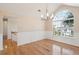 Dining room boasting a large window, hardwood floors, wainscoting, and a modern chandelier at 1144 Clearspring Dr, Charleston, SC 29412