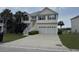 Inviting two-story home with a two-car garage, palm trees, and a well-maintained lawn and garden at 1144 Clearspring Dr, Charleston, SC 29412