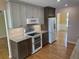 Modern kitchen with stainless steel appliances, light countertops, and hardwood floors at 1144 Clearspring Dr, Charleston, SC 29412