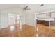 Open-concept living room with hardwood floors, high ceilings, and seamless flow to the kitchen and entry foyer at 1144 Clearspring Dr, Charleston, SC 29412