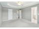 Bright main bedroom with ceiling fan, tray ceiling, and access to ensuite bathroom at 1144 Clearspring Dr, Charleston, SC 29412