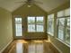 Cozy sunroom with vaulted ceilings and windows offering a serene view of the lake at 1144 Clearspring Dr, Charleston, SC 29412