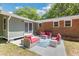 Charming patio area with red cushions, stylish furniture and an outdoor rug at 1172 Dawn Dr, Charleston, SC 29412
