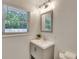 A bathroom featuring a window, a grey vanity, and a plant at 1172 Dawn Dr, Charleston, SC 29412