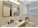 Bathroom view with sink and wooden vanity, plus a mirror reflecting the tiled shower at 1172 Dawn Dr, Charleston, SC 29412