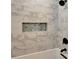 Modern bathroom features a shower with a built-in shelf and stylish marble tiling at 1172 Dawn Dr, Charleston, SC 29412