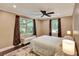 A cozy bedroom with two large windows, dark wood floors, and decorative curtains at 1172 Dawn Dr, Charleston, SC 29412