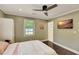 This bedroom features a ceiling fan and television, and a door to an additional room at 1172 Dawn Dr, Charleston, SC 29412