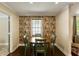 Cozy dining area featuring a round wooden table, green chairs and wallpapered accent wall with lots of natural light at 1172 Dawn Dr, Charleston, SC 29412