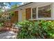 Charming brick home featuring a bright yellow front door and lush greenery around the entrance at 1172 Dawn Dr, Charleston, SC 29412