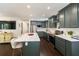 A spacious kitchen features gray cabinets, stainless appliances, a large island with seating and white countertops at 1172 Dawn Dr, Charleston, SC 29412