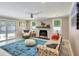 Spacious living room boasts natural light, a fireplace, stylish furnishings and sliding glass door at 1172 Dawn Dr, Charleston, SC 29412