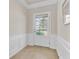 Welcoming foyer with tile flooring, wainscoting, and a front door with glass panels at 118 Billowing Sails St, Summerville, SC 29486