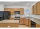 Well-equipped kitchen with stainless steel appliances, granite countertops, and light wood cabinets at 118 Billowing Sails St, Summerville, SC 29486