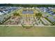 Overhead image of an amenity center with a pond, playground, seating area, and bocce ball courts at 1226 Spotflower St, Summerville, SC 29485