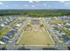 Aerial view of homes surrounding an amenity center with a pond and playground at 1226 Spotflower St, Summerville, SC 29485