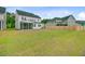 Large backyard with green grass and a wooden fence, offering privacy and space for recreation at 1226 Spotflower St, Summerville, SC 29485