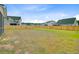 Large grassy backyard enclosed by a wooden fence, providing a secure and private outdoor space at 1226 Spotflower St, Summerville, SC 29485