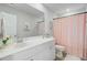 Bright bathroom featuring a white vanity with a large mirror, a stylish shower curtain, and modern fixtures at 1226 Spotflower St, Summerville, SC 29485