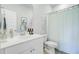 Clean bathroom with a white vanity, toilet, framed artwork, and a shower with a striped curtain at 1226 Spotflower St, Summerville, SC 29485