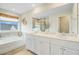 Bright bathroom featuring double vanity, soaking tub, and decorative accents at 1226 Spotflower St, Summerville, SC 29485