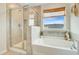 Bright bathroom featuring tiled shower, soaking tub, and natural light at 1226 Spotflower St, Summerville, SC 29485