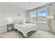 Bright bedroom featuring a white metal bed frame, carpet, and two windows letting in natural light at 1226 Spotflower St, Summerville, SC 29485