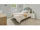 Cozy bedroom with white linens, blue accents and natural light at 1226 Spotflower St, Summerville, SC 29485