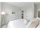 Neutral bedroom showcasing white walls, a bed, carpet, and a view into the kitchen at 1226 Spotflower St, Summerville, SC 29485