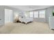 Spacious bedroom with a ceiling fan, carpet, and three large windows at 1226 Spotflower St, Summerville, SC 29485