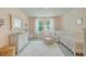 Charming Bedroom with crib, rocker, soft colors, and natural light at 1226 Spotflower St, Summerville, SC 29485