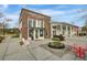 Charming corner cafe featuring brick and white accents, complemented by a tranquil water feature and outdoor seating at 1226 Spotflower St, Summerville, SC 29485