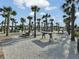 Relaxing common area with picnic tables and fire pit amidst a grove of palm trees at 1226 Spotflower St, Summerville, SC 29485