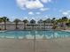 Stunning community pool with clear water, poolside seating, and tropical landscaping at 1226 Spotflower St, Summerville, SC 29485