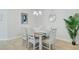 Elegant dining area with a coastal-themed table setting and a contemporary chandelier at 1226 Spotflower St, Summerville, SC 29485