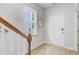 Hallway with wood-look floors, neutral walls, and a white door at 1226 Spotflower St, Summerville, SC 29485