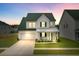 Charming two-story home with a well-manicured lawn, attached garage, and inviting front porch at 1226 Spotflower St, Summerville, SC 29485