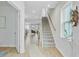 Bright foyer featuring hardwood floors, a staircase, and views into the living and dining areas at 1226 Spotflower St, Summerville, SC 29485