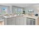 Open kitchen with a large island, stainless steel appliances, and seamless flow to living room at 1226 Spotflower St, Summerville, SC 29485