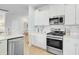 Modern kitchen featuring stainless steel appliances, white cabinets, and ample countertop space at 1226 Spotflower St, Summerville, SC 29485
