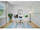 Bright, modern office with a large window, white desk, and a stylish blue accent rug at 1226 Spotflower St, Summerville, SC 29485