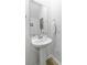 Classic powder room featuring a pedestal sink, patterned wallpaper, and updated hardware at 1226 Spotflower St, Summerville, SC 29485