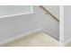 Carpeted stairs showcasing white walls, updated trim, and wood-look flooring at 1226 Spotflower St, Summerville, SC 29485