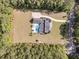Aerial image featuring a home, pool, outbuilding, and a driveway surrounded by lush greenery at 1245 Saddlehorn Rd, Summerville, SC 29486