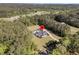 Wide aerial view showcasing a home with a pool and long drive nestled within a wooded area at 1245 Saddlehorn Rd, Summerville, SC 29486