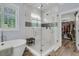 Bathroom showcasing a frameless glass shower, a soaking tub, and a view into the closet at 1245 Saddlehorn Rd, Summerville, SC 29486