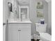 Charming bathroom featuring a granite countertop, white cabinets, and a framed mirror at 1245 Saddlehorn Rd, Summerville, SC 29486