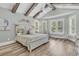 Bright bedroom with wood-look floors, high ceilings with exposed beams, and large windows with plantation shutters at 1245 Saddlehorn Rd, Summerville, SC 29486